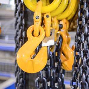 Black steel chain and yellow cargo hooks.